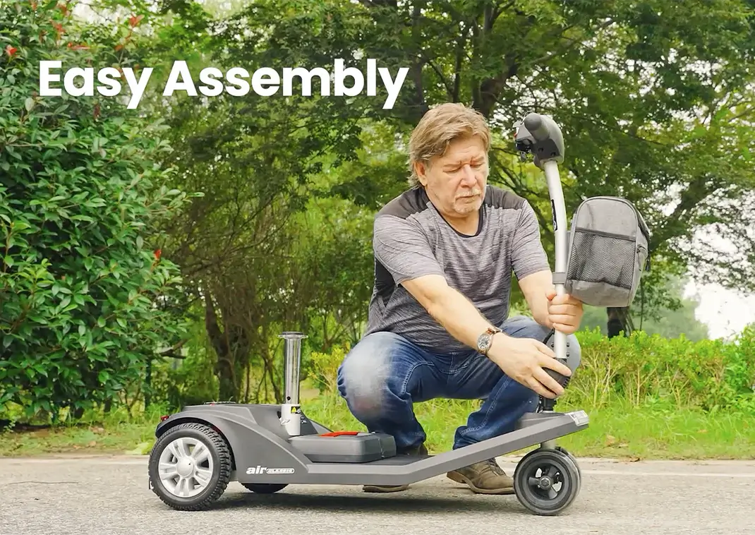 A boy riding a scooter in a park.