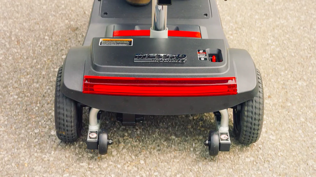 Close-up of a wheeled cleaning machine on pavement.