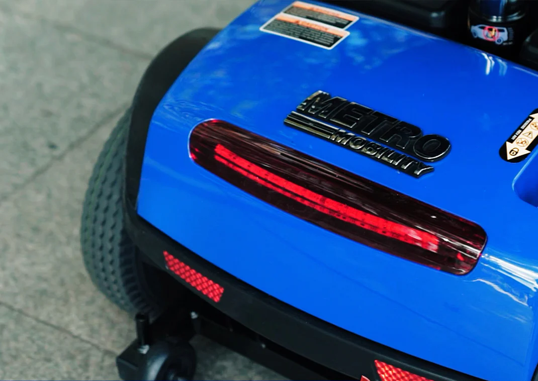 Close-up of a blue toy car's rear with red taillights.
