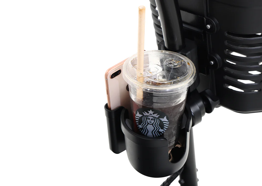 Stroller cup holder with Starbucks iced drink and smartphone.