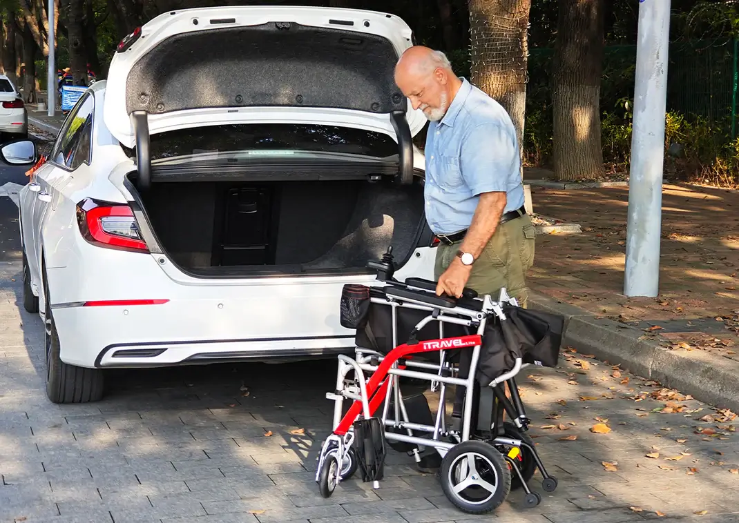 An elderly man with a walker loading items into a car trunk.